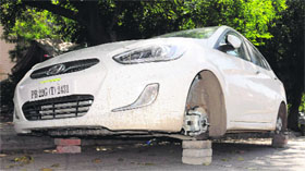 A car supported on bricks after thieves took away its tyres at Sector 15 in Chandigarh on Thursday.