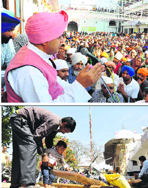 Mahant Devendra Das addresses the devotees at Jhanda Sahib. (Below) A man prays alongwith his child to the new wooden mast of Jhanda Sahib in Dehradun on Thursday.