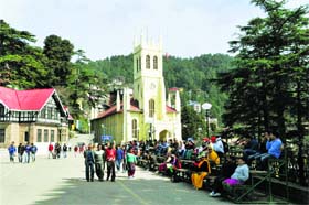 People enjoy a sunny day on the Ridge in Shimla on Thursday