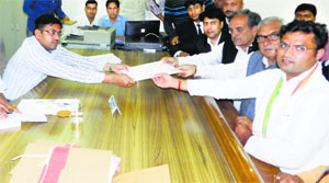 State Congress president Ashok Tanwar files his nomination papers as CM Bhupinder Singh Hooda and Rajya Sabha member Birender Singh assist him in Sirsa on Thursday.