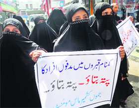 Members of the Jammu and Kashmir Mass Movement hold placards during a protest demanding the release of all Kashmiri prisoners held in jails and whereabouts of disappeared Kashmiri youth in Srinagar on Thursday.