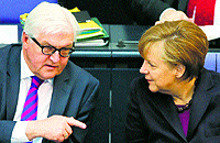 German Chancellor Angela Merkel (R) listens to Foreign Minister Frank-Walter Steinmeier during a session of the lower house of Parliament, the Bundestag, in Berlin om Thursday