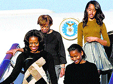 US First Lady Michelle Obama, front left, along with her daughters and mother arrives at Capital International Airport in Beijing, China, on Thursday