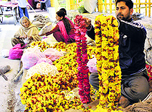 A roadside vendor sells garlands after the demand witnessed a spurt following poll announcement