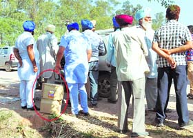 Akali workers ferrying liquor cases at Ghanaur on Thursday