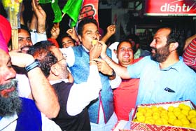 Congress men celebrate with laddoos in Amritsar on Friday