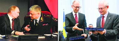 Russian President Vladimir Putin speaks with Interior Minister Vladimir Kolokoltsev during a meeting in Moscow; and (right) European Council president Herman Van Rompuy (R) exchanges documents with Ukrainian Prime Minister Arseniy Yatsenyuk during the signing of the political provisions of the Association Agreement with Ukraine at the EU headquarters in Brussels on Friday