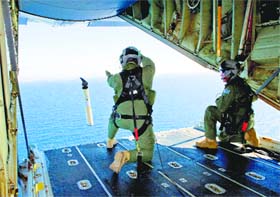Royal Australian Air Force Loadmasters launch a self locating data marker buoy in the southern Indian Ocean as part of Australia's assistance in the search for MH370