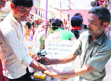 A man gets a tattoo made on his arm during the Jhanda Mela in Dehradun.