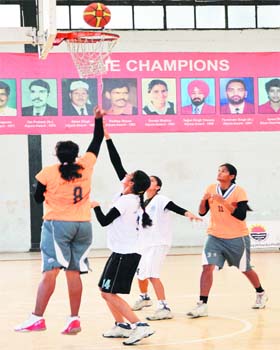 A match in progress on the penultimate day of the inter-college basketball league in Ludhiana on Saturday
