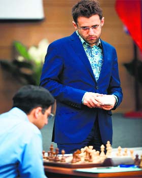 Viswanathan Anand ponders his next move while Levon Aronian keeps a close watch during their eighth-round match of the Candidates Chess tournament on Saturday