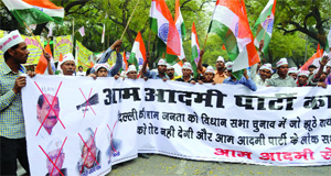 Activists of the Aam Aadmi Sena shout slogans during a demonstration against the AAP at Jantar Mantar in New Delhi on Sunday.