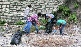 Volunteers of MAD clean the Sahastradhara area in Dehradun on Sunday.