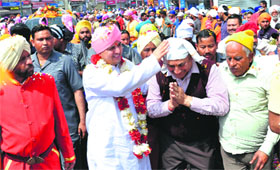 Mahant Devendra Dass blesses a devotee during a nagar parikarama in Dehradun on Sunday.