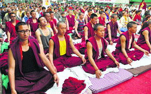 Monks take part in a yoga camp organised by the Patanjali Yogpeeth on the occasion of Shaheedi Diwas in Dharamsala on Sunday