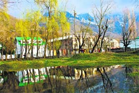 Play time: Children play cricket on the banks of the Dal Lake in Srinagar