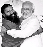 Yoga guru Baba Ramdev hugs BJPs prime ministerial candidate Narendra Modi during Yoga Mahotsav at Ramlila Maidan in New Delhi on Sunday