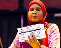 A poll officer holds up marked ballot papers in Male on Sunday