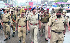 Paramilitary and city police conduct a flag march in the walled city in the wake of coming Lok Sabha elections in Amritsar on Monday.