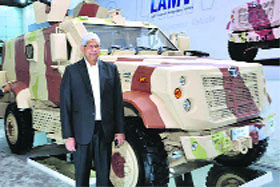Tata Motors vice-president Vernon Noronha poses with a combat vehicle.