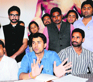 Nigam Bhandari (centre), general secretary, NSUI, addresses mediapersons in Chandigarh.
