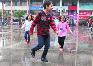 Children enjoy the showers in Sector 17, Chandigarh, on Monday.