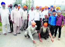 Daban Kheri villagers protest against poor construction of road. They also seized the contractor's road roller on Sunday. Photo: Satish Seth