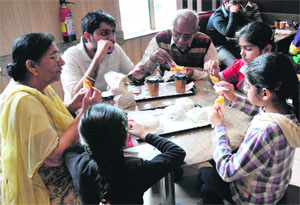 A family enjoys breakfast in Jalandhar on Monday. 