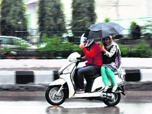 A couple braves the rain in Jammu on Monday.
