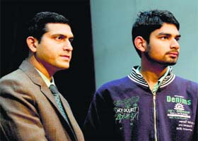 Deputy Commissioner Rajat Aggarwal hands over a voter card to a student during a function