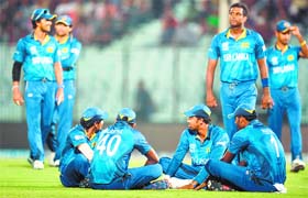 Sri Lanka players sit on the ground after the stadium floodlights malfunctioned during the match between Netherlands and Sri Lanka at The Zahur Ahmed Chowdhury Stadium