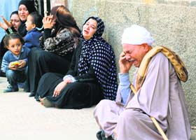 Relatives of supporters of ousted Islamist president Mohamed Morsi cry sitting outside the courthouse in Minya on Monday