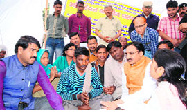Former Chief Minister and BJP candidate from Haridwar Lok Sabha seat Ramesh Pokhriyal Nishank meets the family members of the Dalit girl in Dehradun on Tuesday.