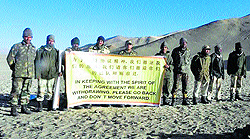 Indian troops show a banner asking Chinese troops to withdraw