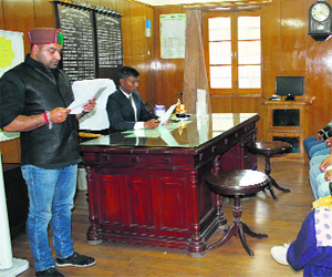 DC KS Vasant administers oath of office to Amit Bharmouri as Zila Parishad chairman in Chamba on Tuesday.
