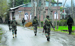 Security forces personnel carry out a search operation in the Tral area of Pulwama district on Tuesday after some militants escaped the security cordon on Monday evening