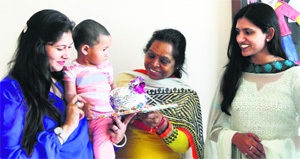 A child receives a prize during the graduation ceremony at Pallavan, a pre-school, in Ludhiana on Tuesday.