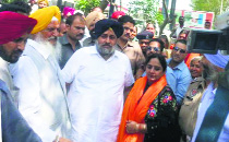 Deputy Chief Minister Sukhbir Badal (third from left) presents a siropa to Neelam Kohli at Meherban village, Ludhiana, on Tuesday.