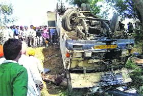 The overturned bus near Butahri village on Tuesday