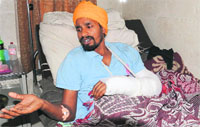Injured Ravinder Singh in Bathinda on Wednesday. Tribune photo