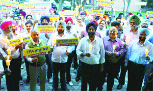 Power engineers hold a candlelight march in Ludhiana.