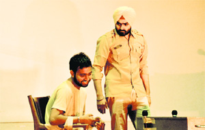 Artistes enact a scene from a play.