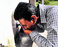 A man drinks water at the Civil Hospital in Amritsar