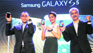 Samsung officials along with a model at the launch of Galaxy S5 smartphone in New Delhi on Thursday.