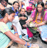 BSP candidate has a meal at Mauli village during her campaign on Thursday. Tribune photo: Pradeep Tewari