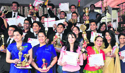 Students in a cheerful mood after receiving prizes during the annual day function at 