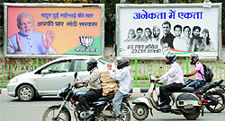 The BJP and Congress hoardings with the key leaders Narendra Modi and Rahul Gandhi placed side by side at the ITO crossing in New Delhi on Thursday