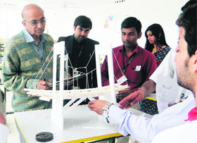 Visitors look at a model during the annual fest of SelaQui Academy of Higher Education in Dehradun on Thursday.