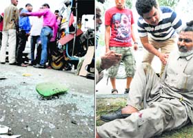 Shards of glass from the cars windowpane are scattered on the road after the accident; and (right) an injured man lies on the Ferozepur Road in Ludhiana on Thursday