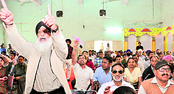 Activists raise slogans against the Congress during a debate organised by the Chandigarh Confederation of Workers and Employees in Chandigarh on Friday